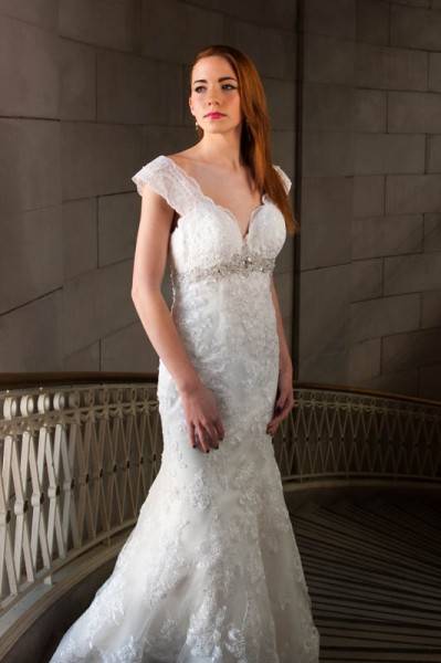 Portrait of a woman wearing a bridal dress on a staircase
