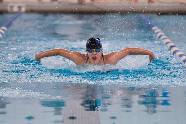 CT-sports-action-photography-swim Sports action photograph of young lady competing in a Connecticut high school swim meet