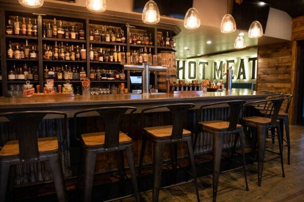 Photograph of the bar at Que Whiskey Kitchen by restaurant interior photographer Bill Morgan.